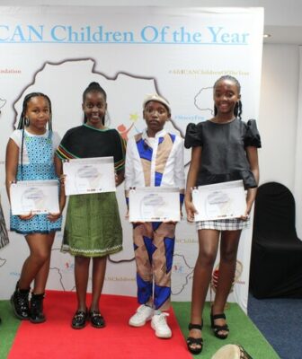 Four children displaying their certificates at the 2022 awards.